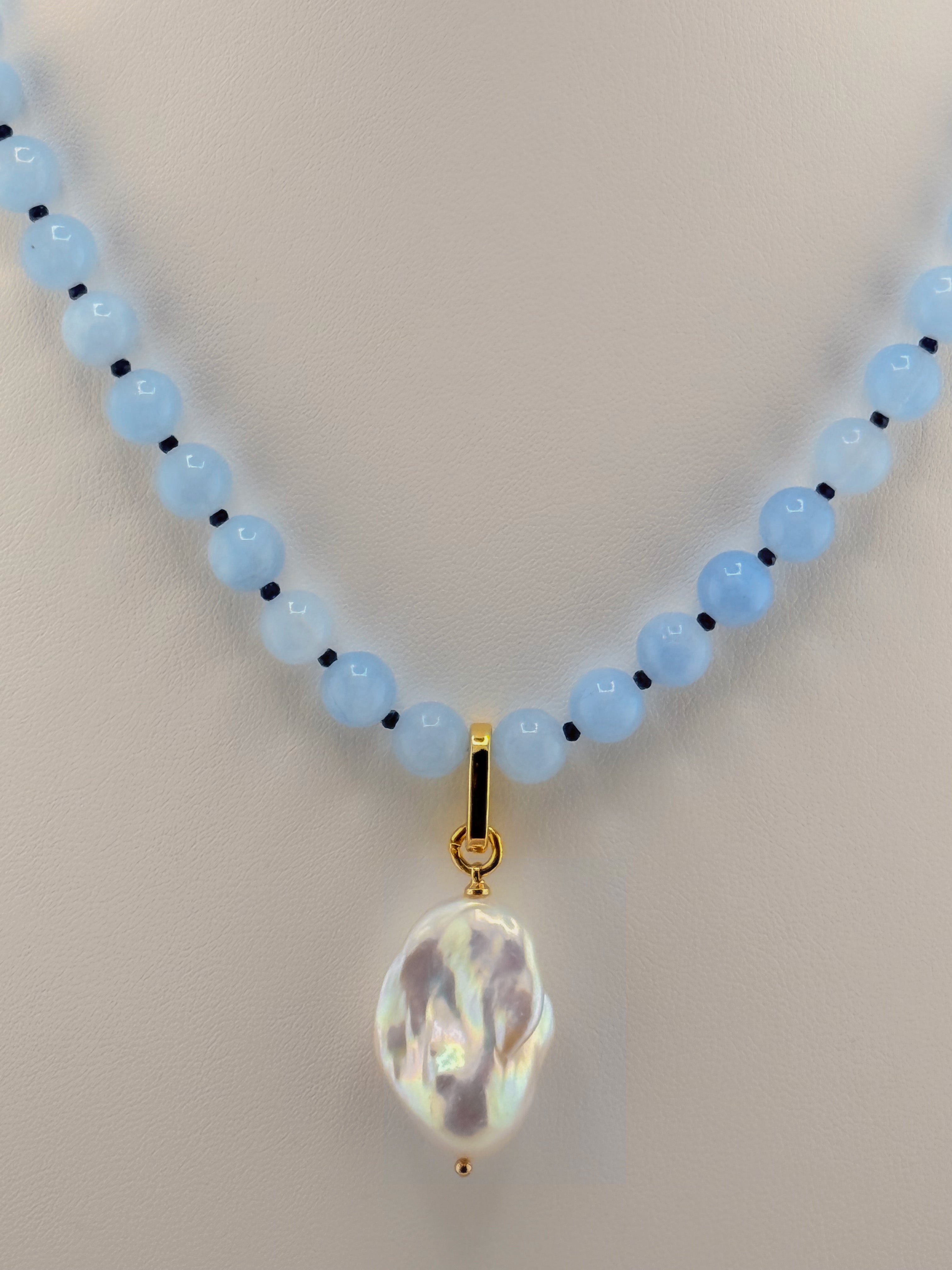 Close-up of the pale aquamarine beads, blue jade accents and baroque pearl