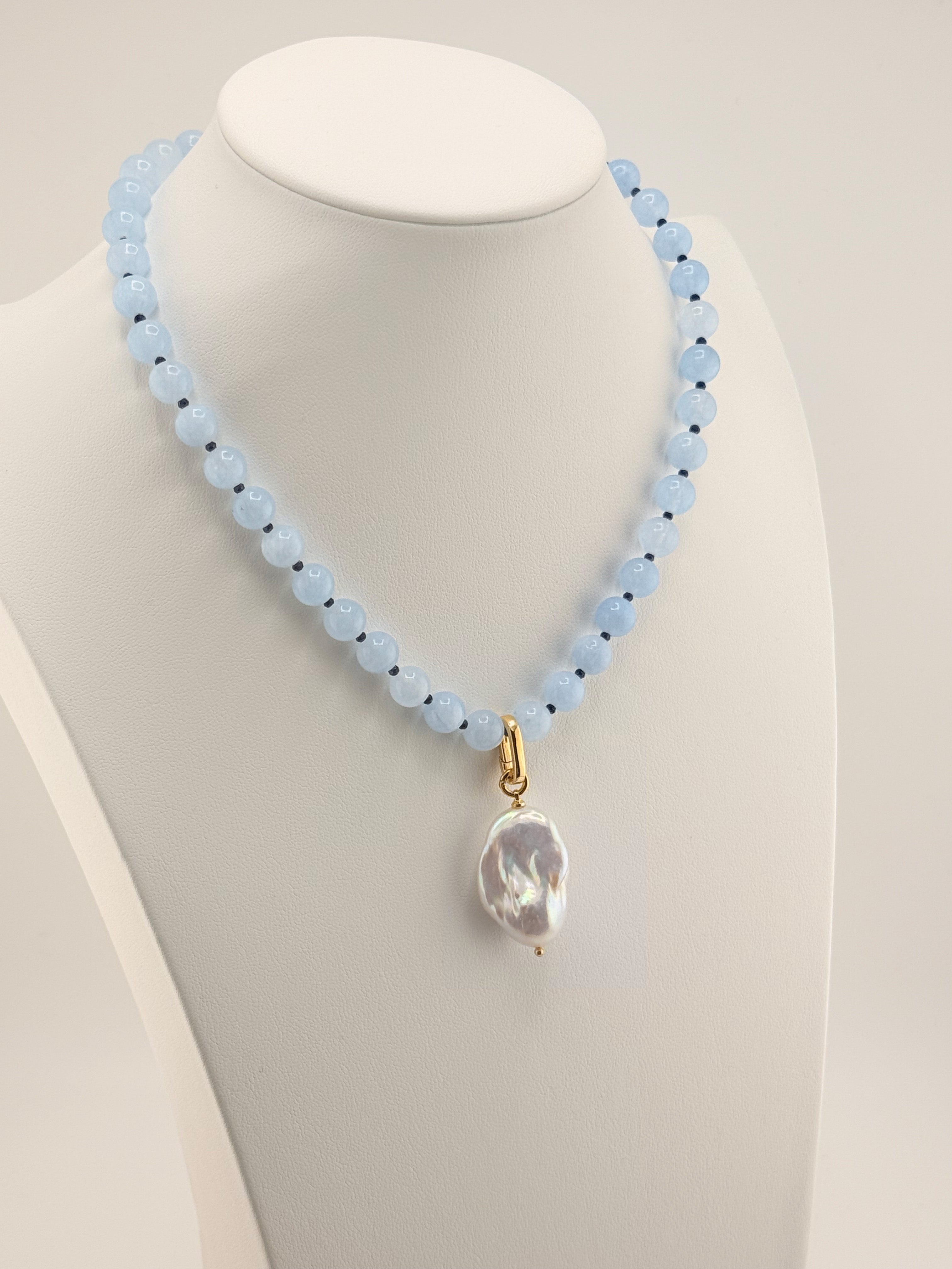 Aquamarine and blue jade necklace with a baroque pearl drop, left-side view