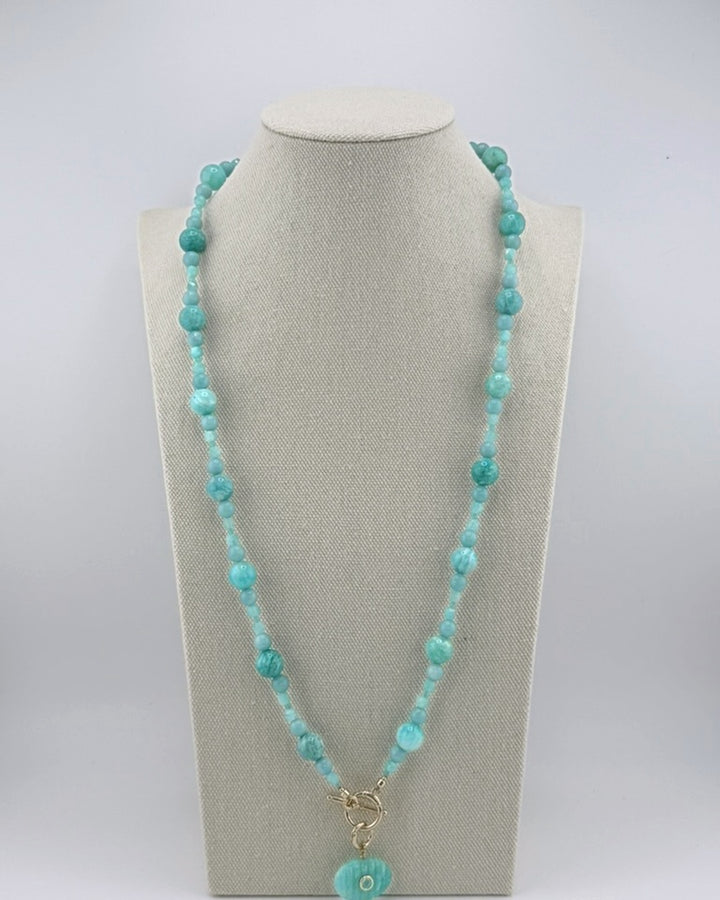 Long amazonite bubble necklace with a carved amazonite oval pendant, full view on a display bust