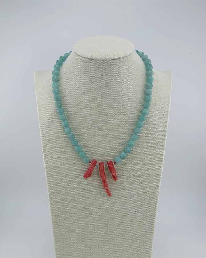 Amazonite and red coral statement necklace, front view on a display bust
