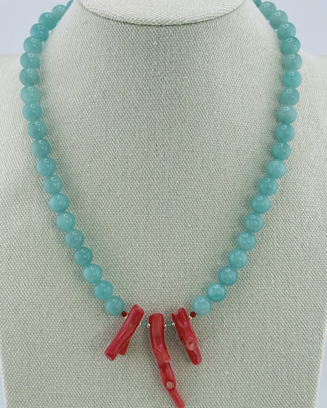 Amazonite bead necklace with a red bamboo coral branch center, front view