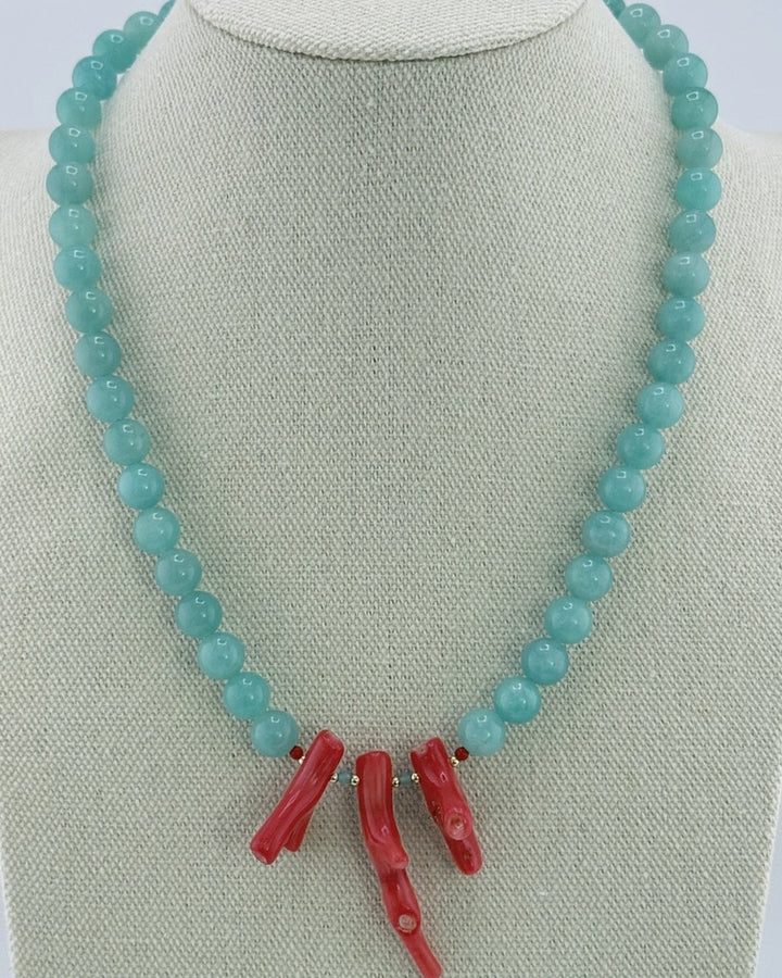 Amazonite bead necklace with a red bamboo coral branch center, front view