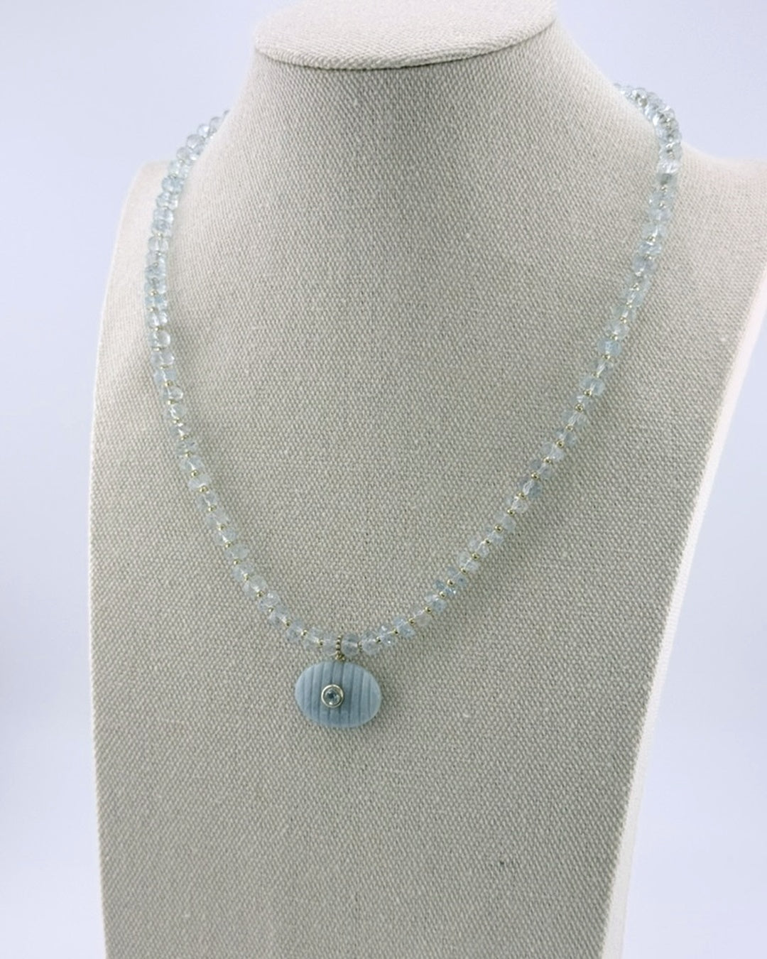 Aquamarine pendant necklace, angled view on the display bust