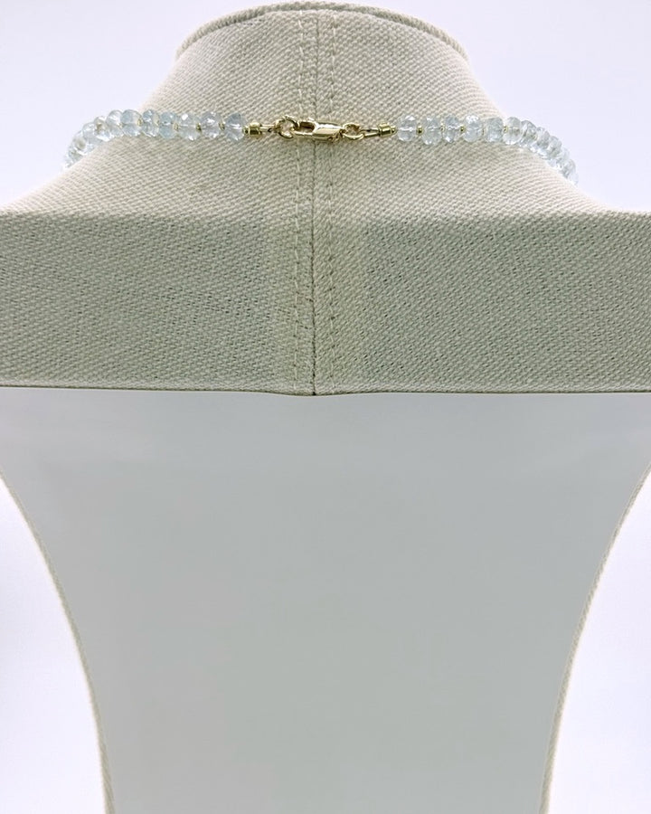 Back view showing the 18k gold-plated lobster clasp on the aquamarine pendant necklace