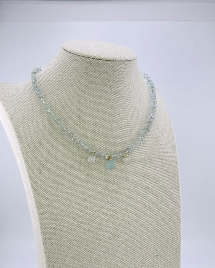 Aquamarine drops necklace, angled view on the display bust