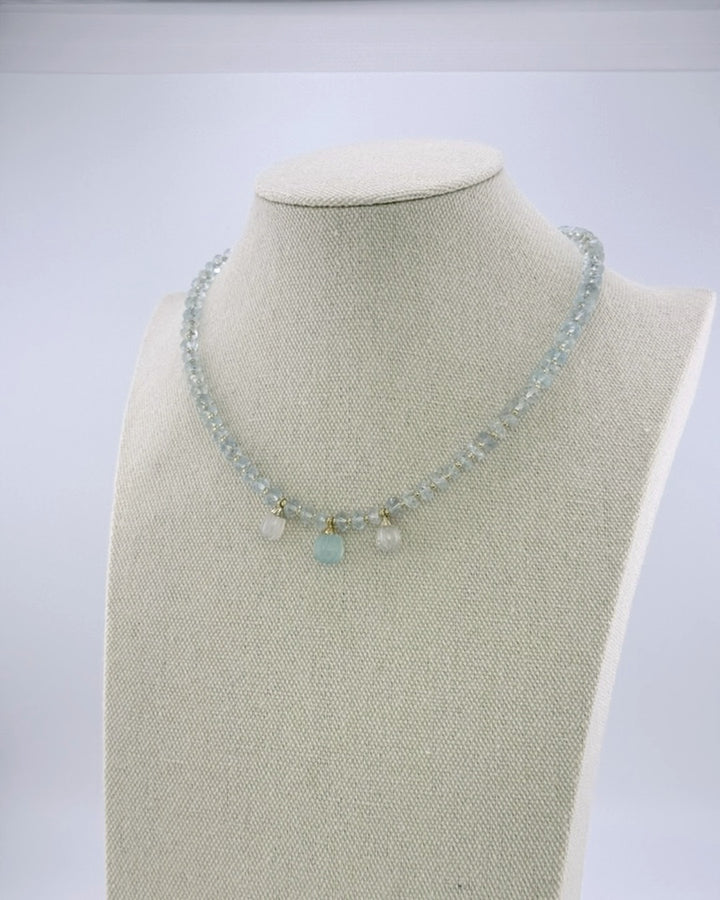 Aquamarine drops necklace, second angled view showing the pale faceted beads