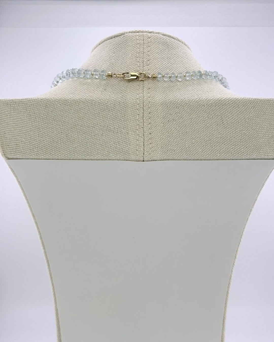 Back view showing the 18k gold-plated lobster clasp on the aquamarine drops necklace