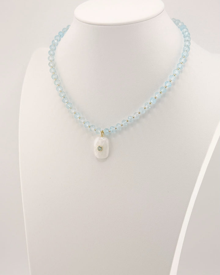 Second angled view of the blue topaz and moonstone pendant necklace