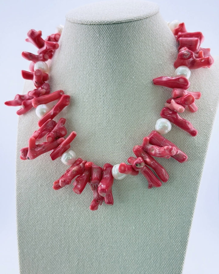 Red coral branch and white pearl statement necklace, front view on a display bust