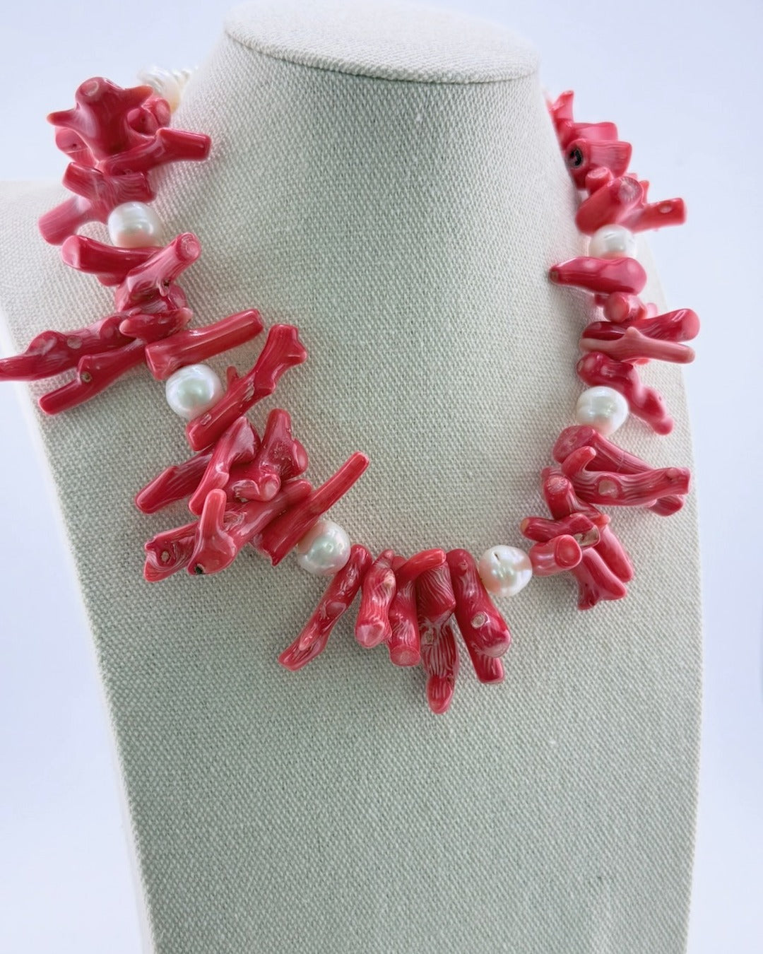 Red coral and pearl statement necklace, angled view showing the coral branches and freshwater pearls