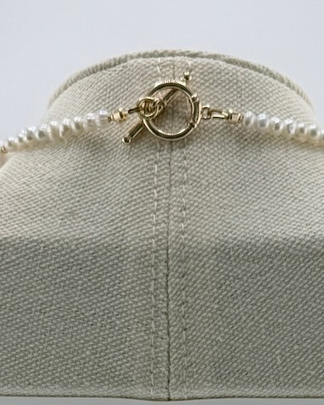 Back view of the necklace showing the 18k gold-plated toggle clasp and small freshwater pearls