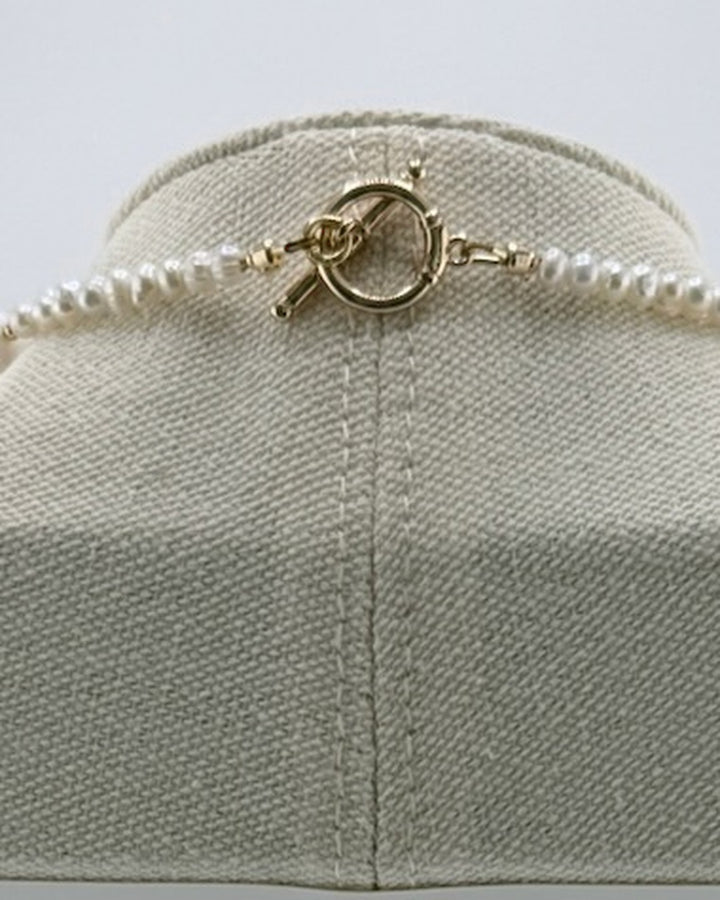 Back view of the necklace showing the 18k gold-plated toggle clasp and small freshwater pearls