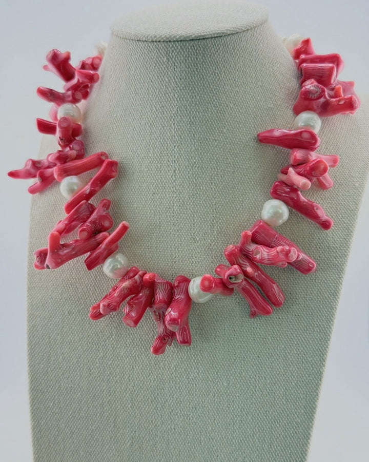 Red coral branch and white pearl statement necklace, front view on a display bust