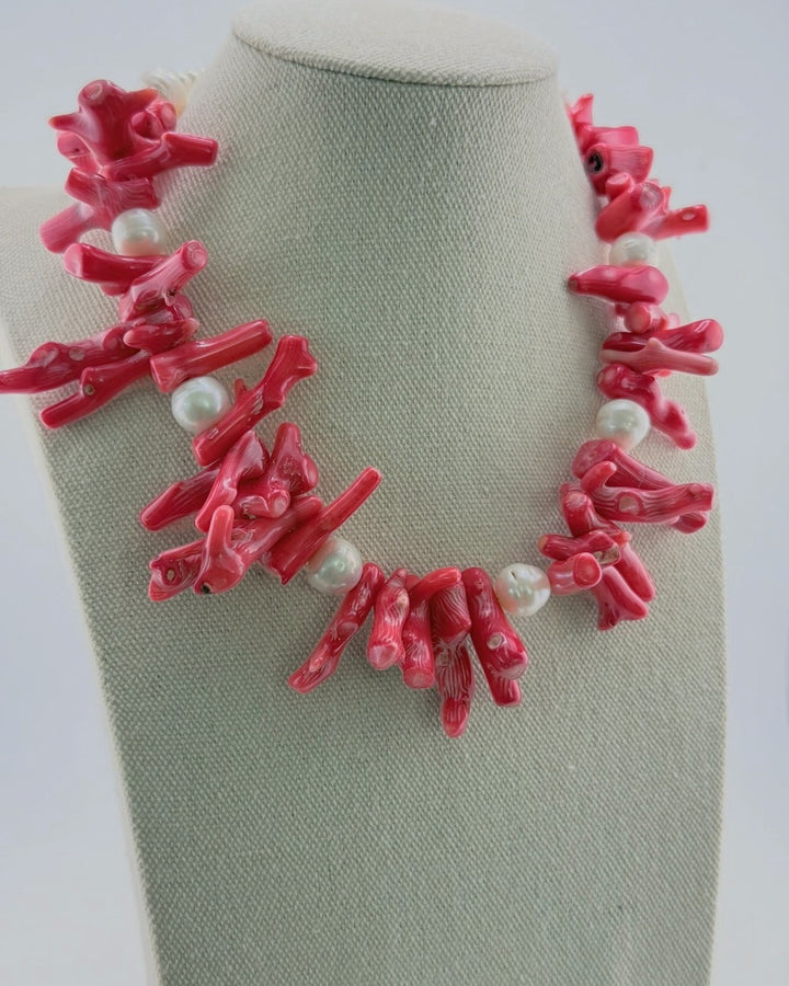Red coral and pearl statement necklace, angled view showing the coral branches and freshwater pearls