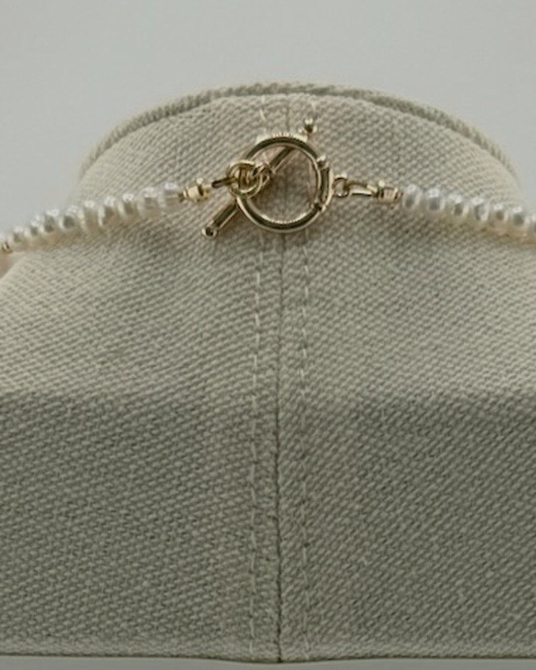 Back view of the necklace showing the 18k gold-plated toggle clasp and small freshwater pearls