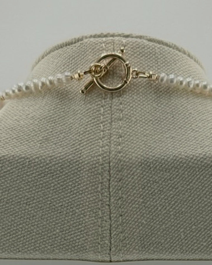 Back view of the necklace showing the 18k gold-plated toggle clasp and small freshwater pearls
