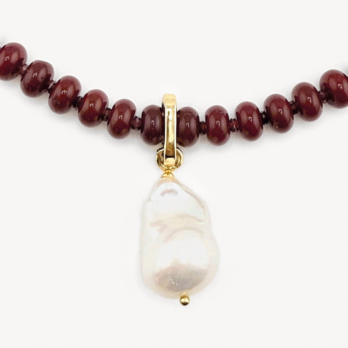 Cultured baroque pearl charm on a gold spring clasp