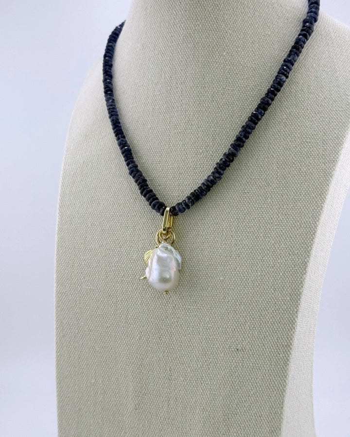 Kyanite and pearl drop necklace, angled full view showing the translucent navy strand