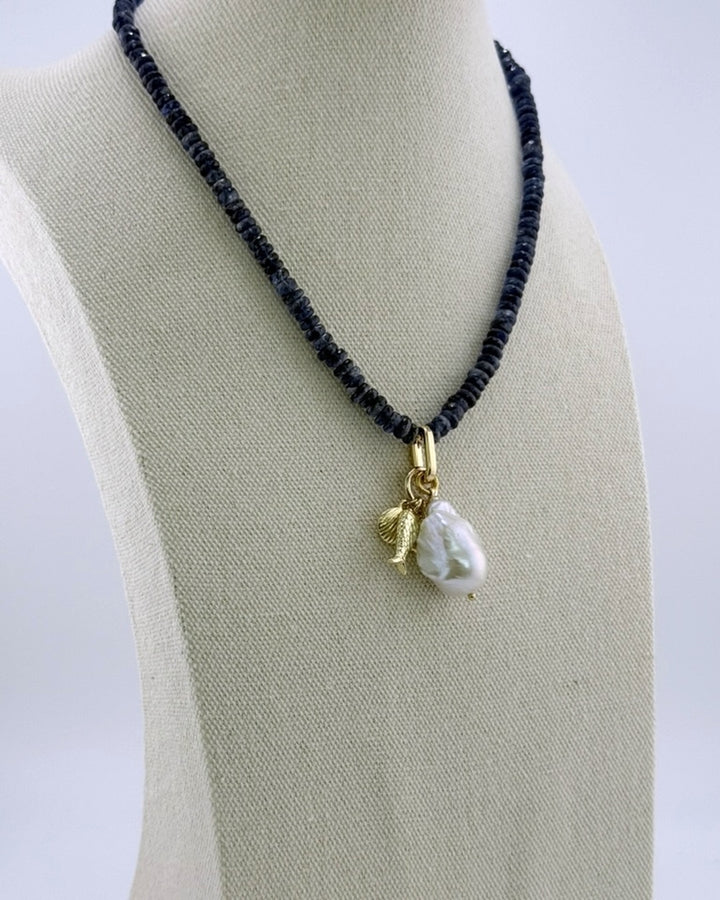 Kyanite and pearl drop necklace, angled view on the display bust