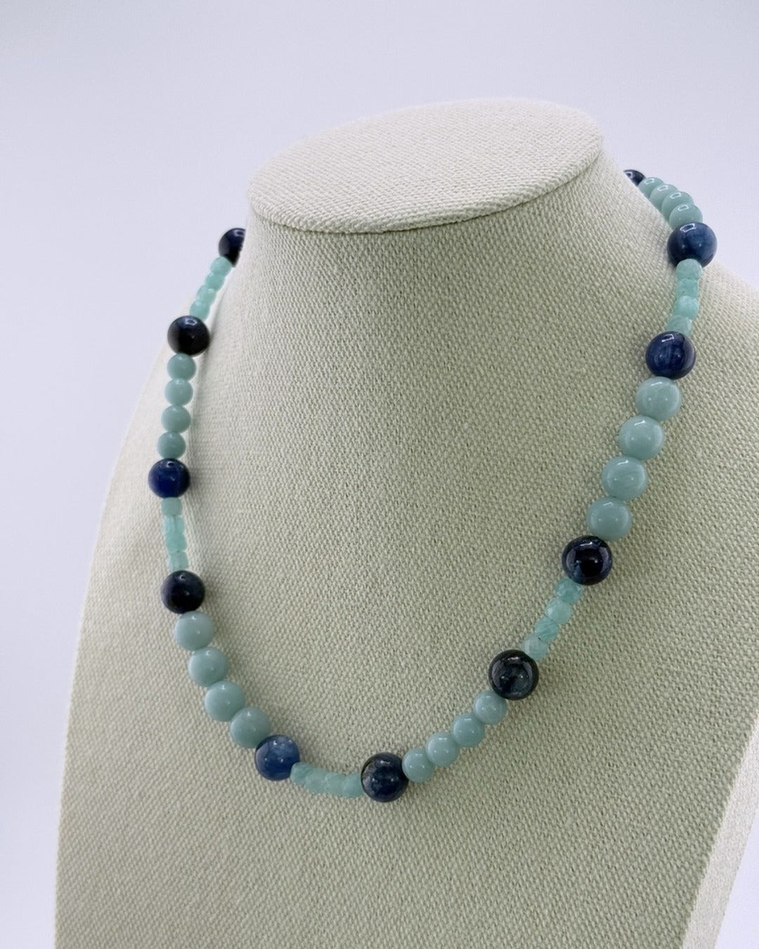 Angled view of the kyanite and amazonite beaded necklace on a bust