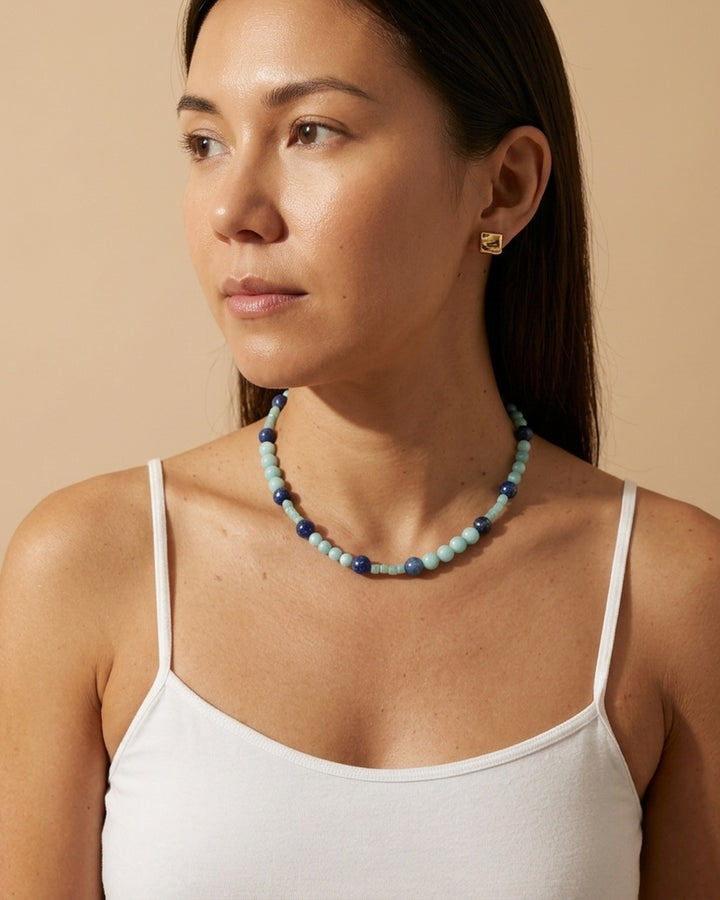 Model in a white cami wearing the kyanite and amazonite beaded necklace at the collarbone