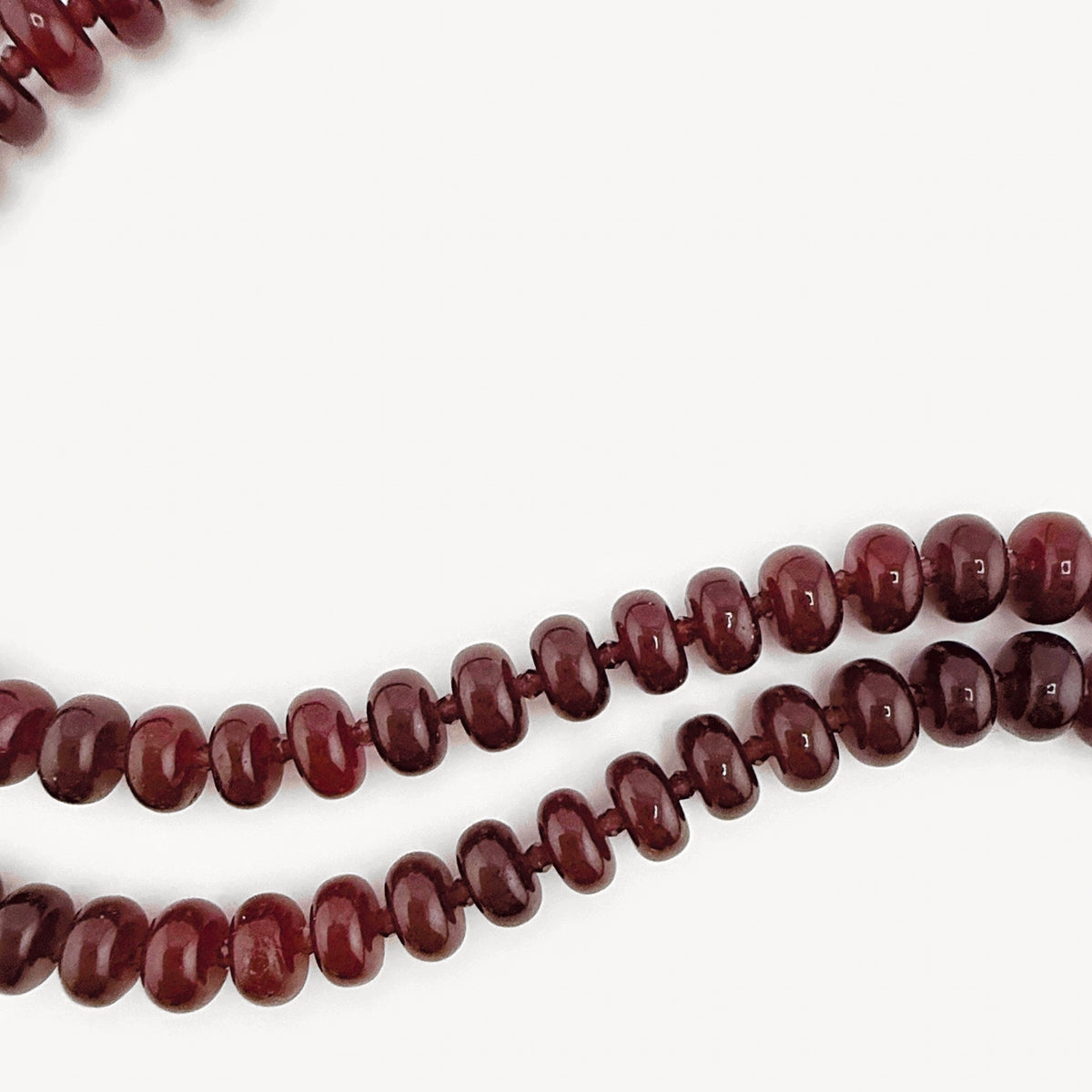 Close-up of the burgundy rondelles on the Lulu Necklace in Burgundy, Long