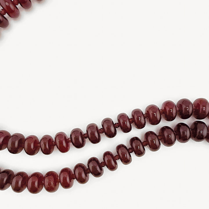 Close-up of the burgundy rondelles on the Lulu Necklace in Burgundy, Long