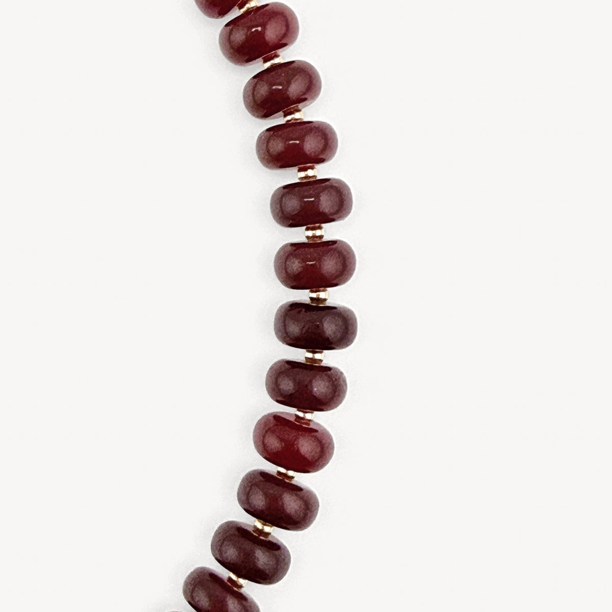 Close-up of the burgundy rondelles on the Lulu Necklace in Burgundy and Olive