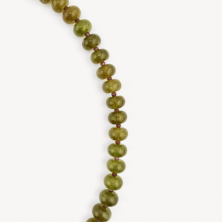 Close-up of the olive rondelles on the Lulu Necklace in Olive