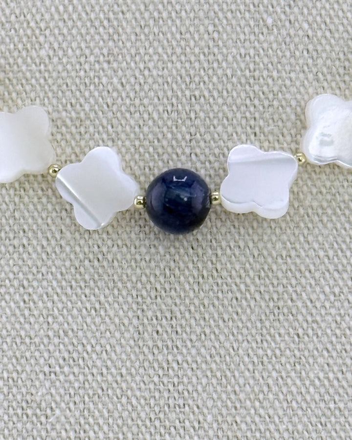 Detail of the mother of pearl quatrefoils and the central navy kyanite bead with small gold accent beads