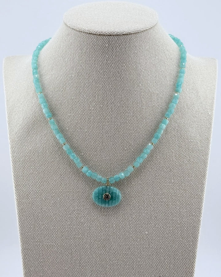 Small amazonite pendant necklace with faceted aqua cube beads and a carved amazonite oval, front view on a display bust