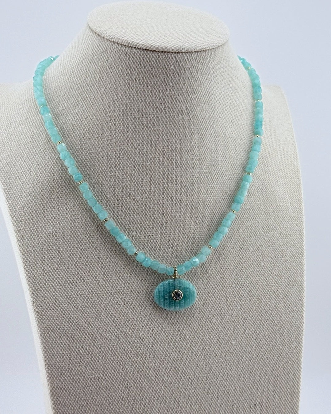 Small amazonite pendant necklace, angled view on the display bust